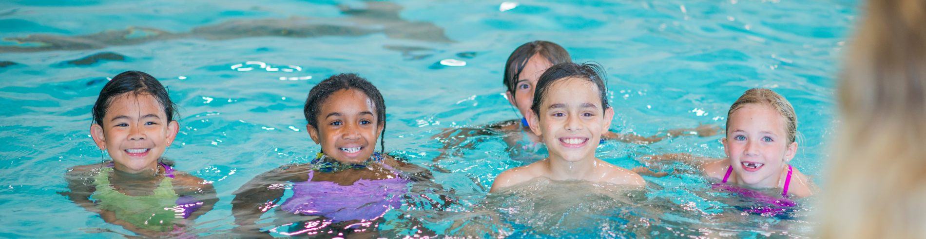 Children in pool with instructor