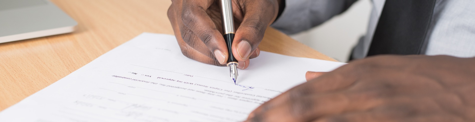 hand signing a form