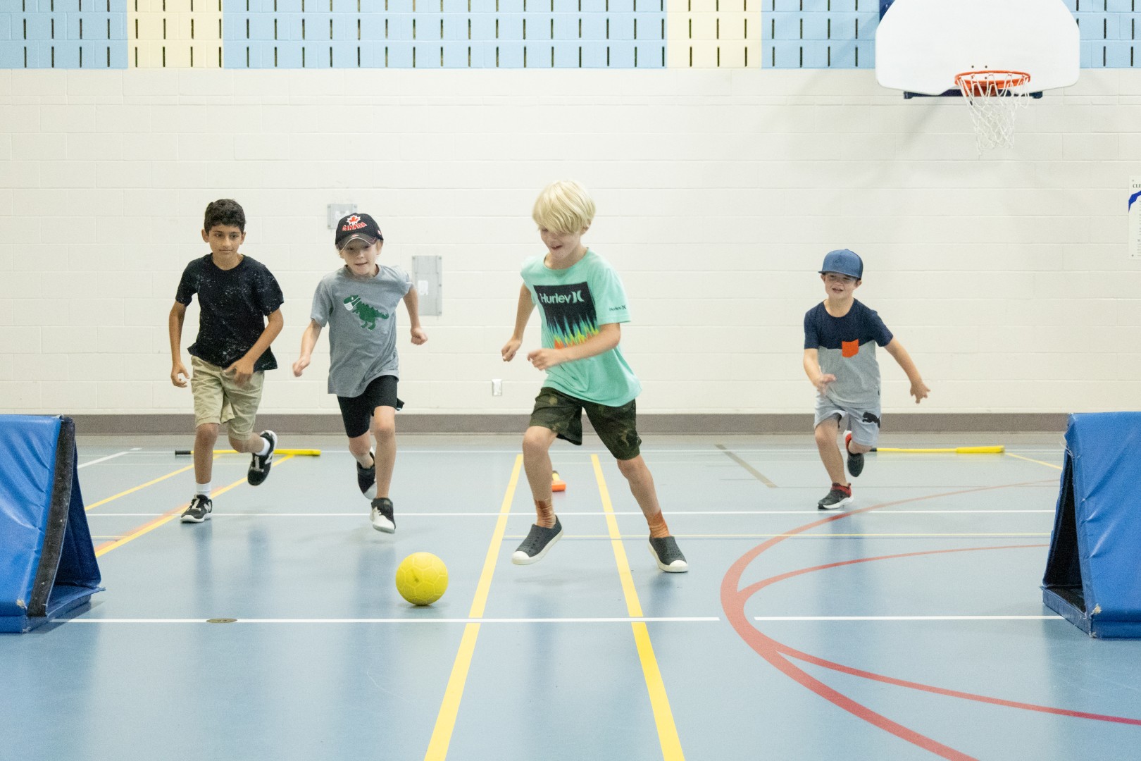 Camper kneeling in Gym - Sports Camp
