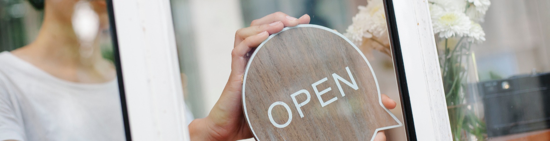 We're Open sign in a store window