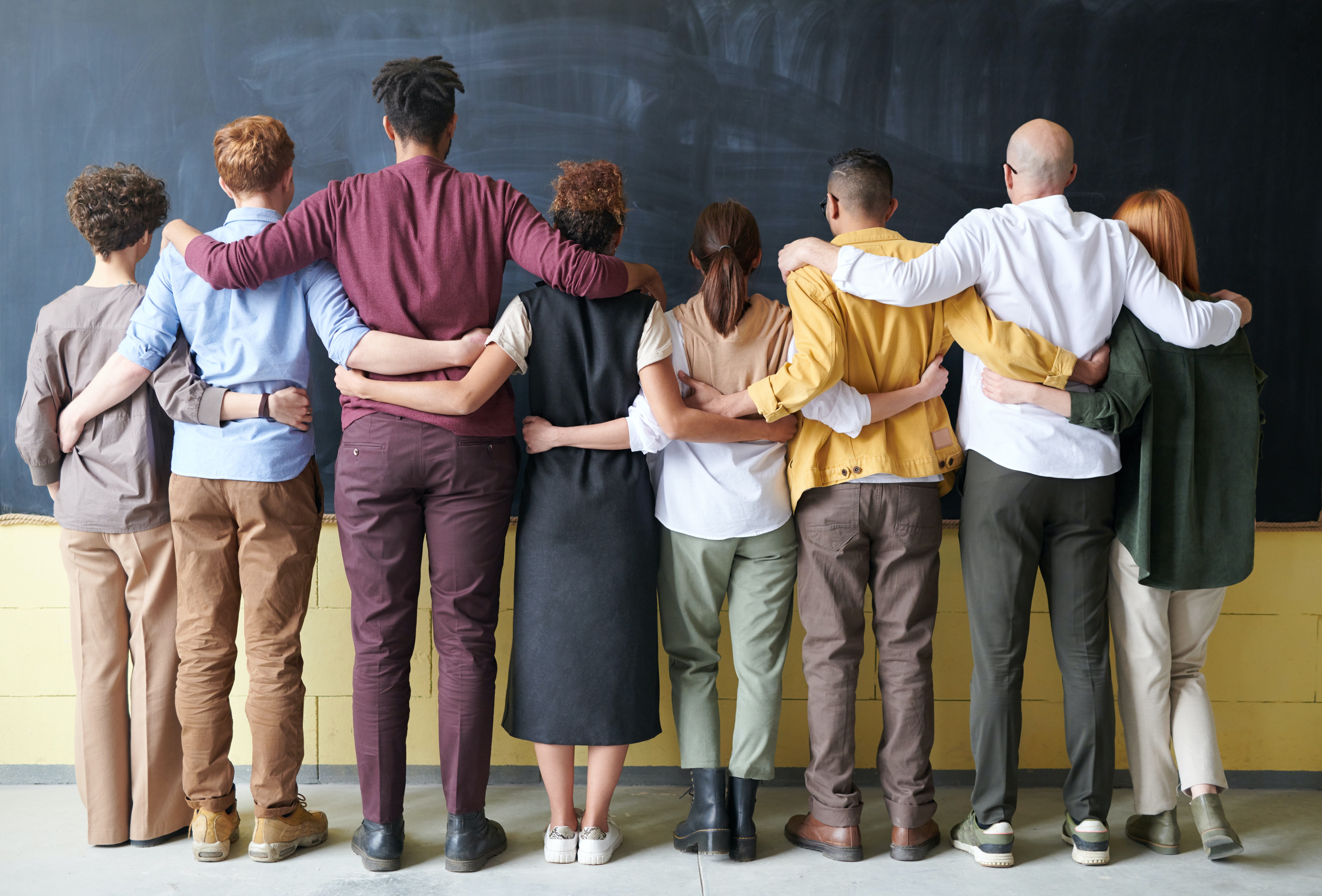 Back of people with arms around each other