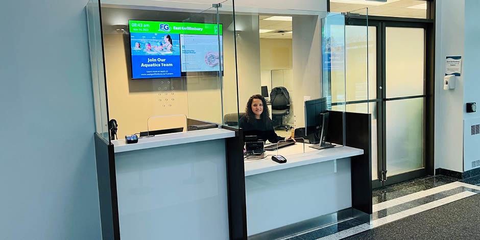 Woman sitting at new Customer Service desk 