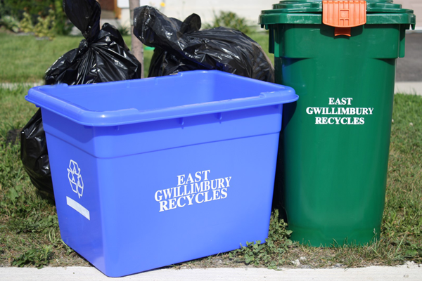 The photo features various waste collection bins