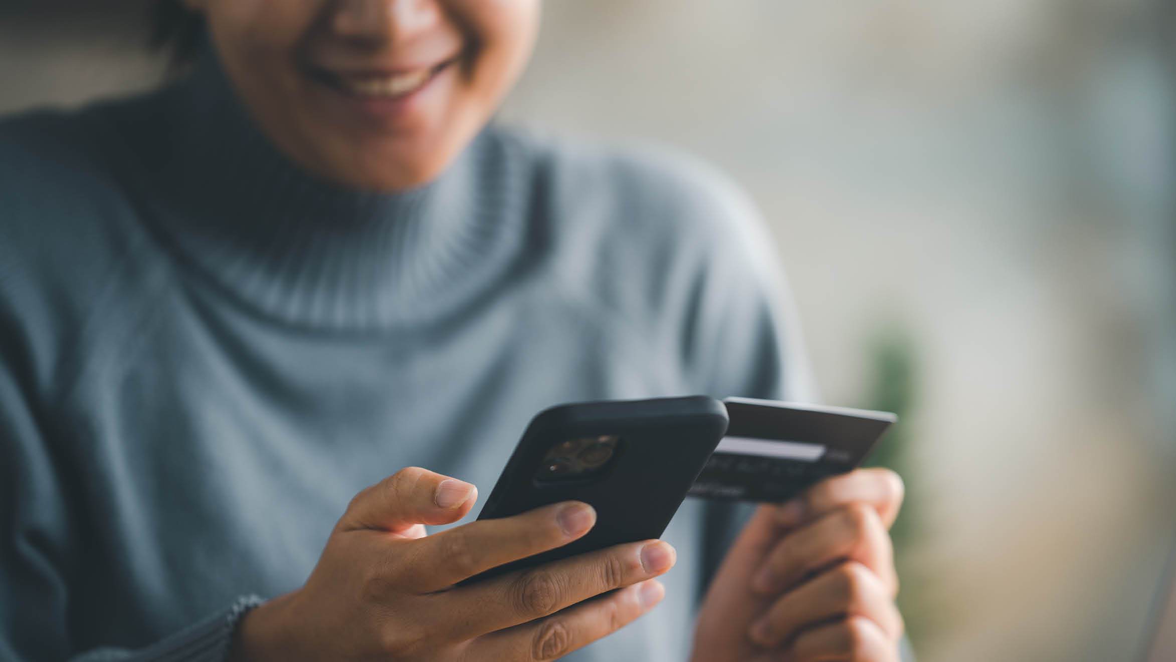 Woman making online purchase on cell phone 