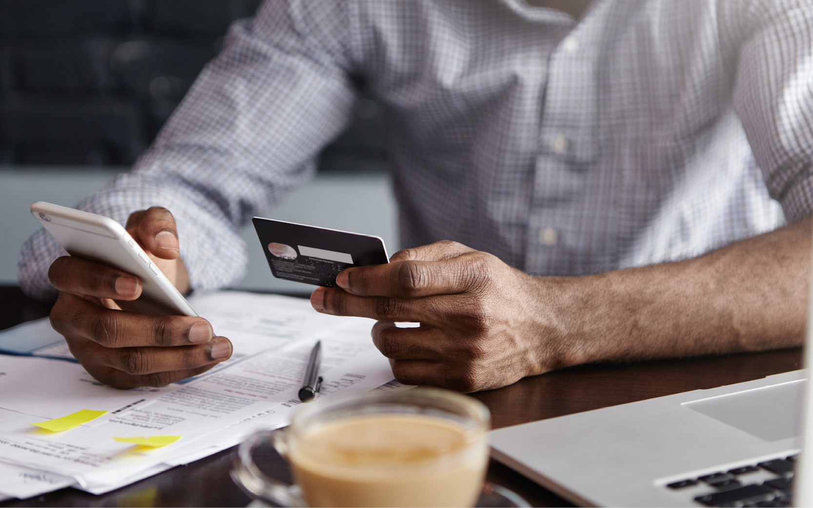 Man holding credit card and phone