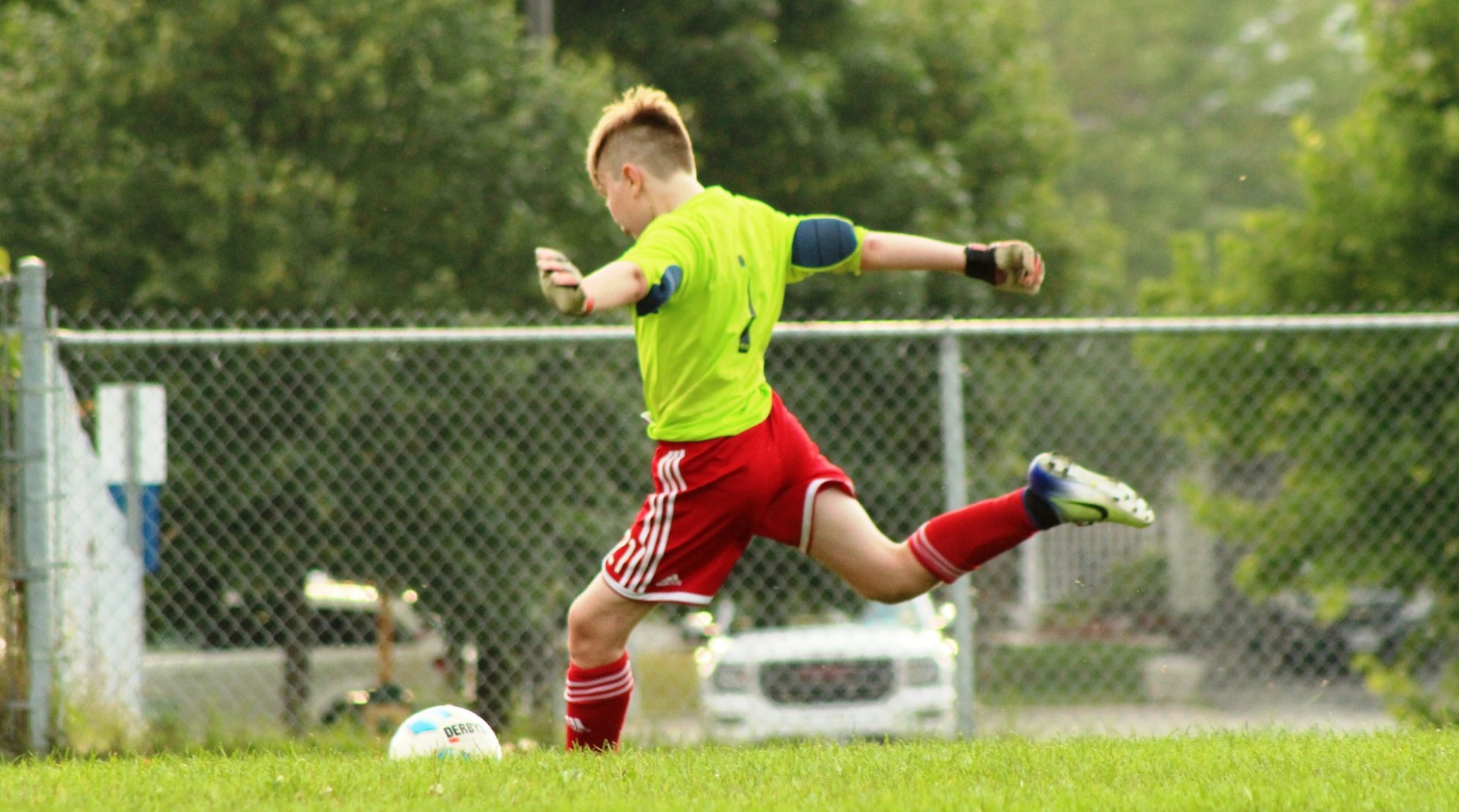 Teammate kicking a soccer ball