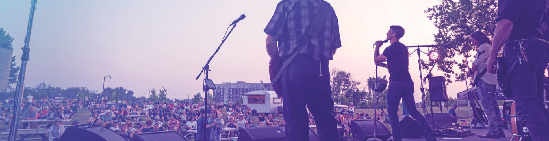 A band on stage looking out to a crowd