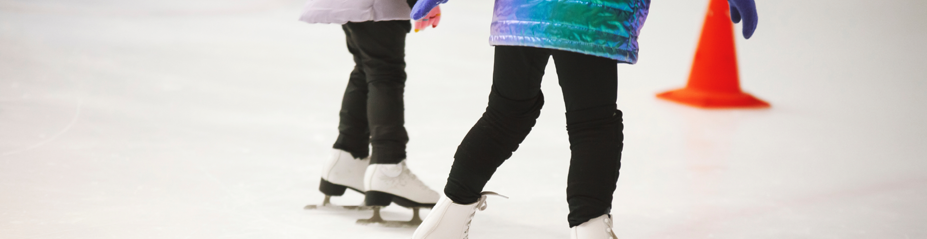 Legs with white figure skates on skating