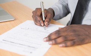 Hand signing a form