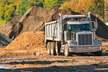 Dump truck in dirt yard