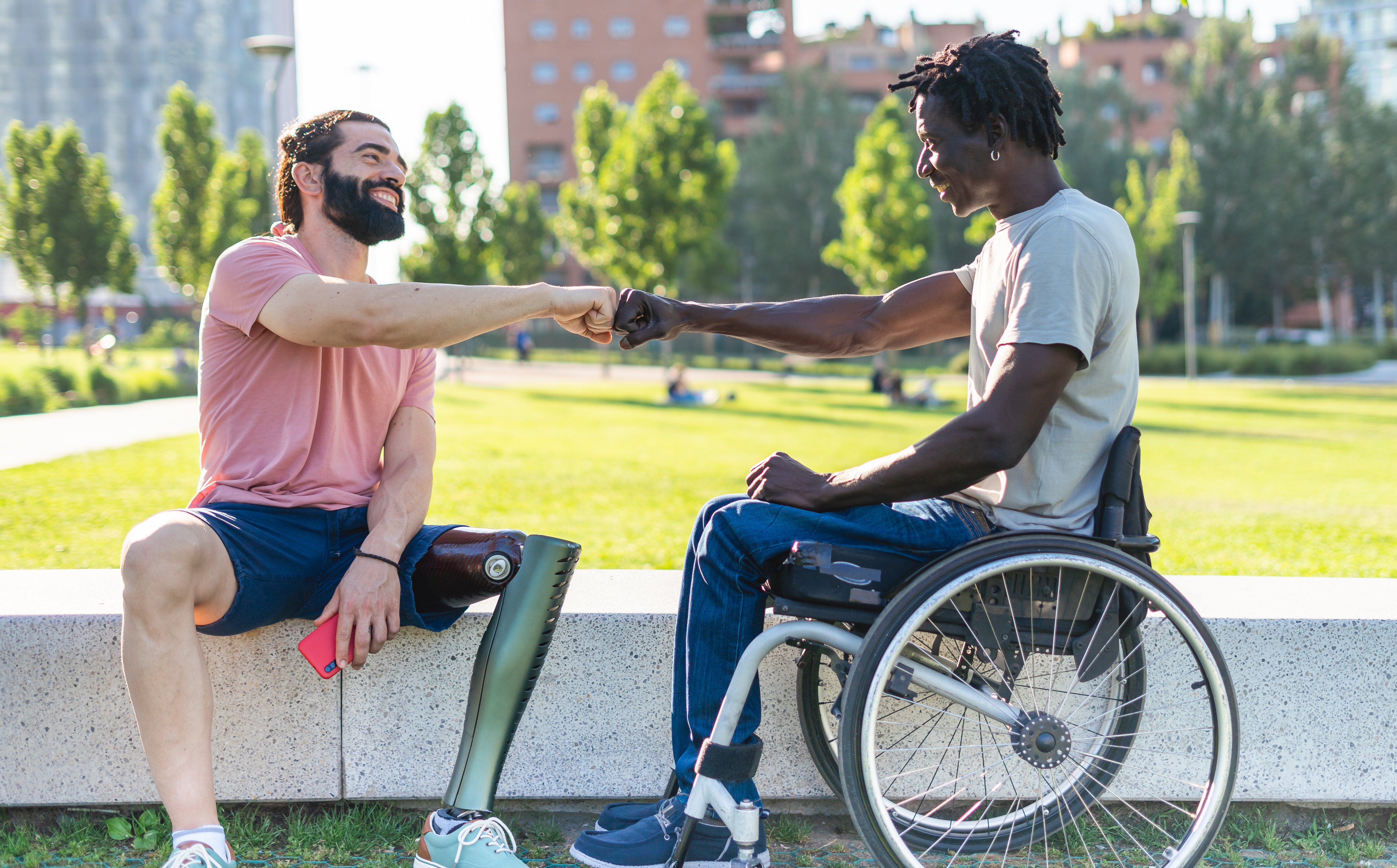 Man in wheelchair and man with prosthetic leg