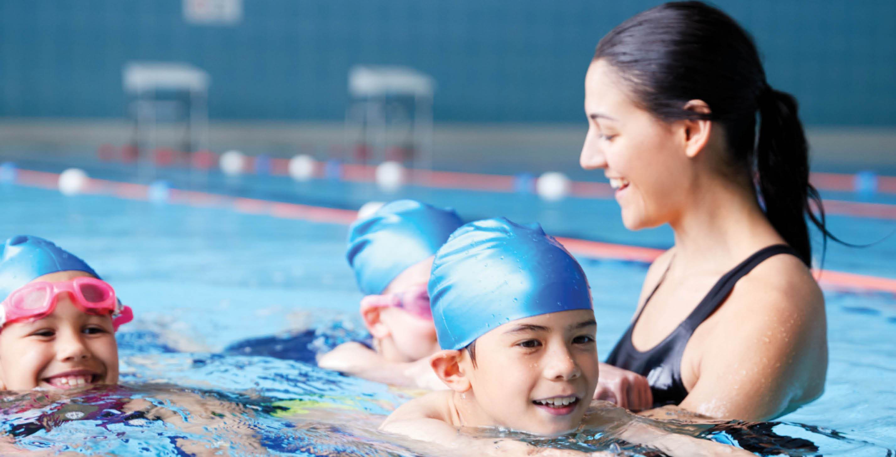 Swimming instructor in pool with children