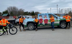 Assorted staff members standing in front of a truck