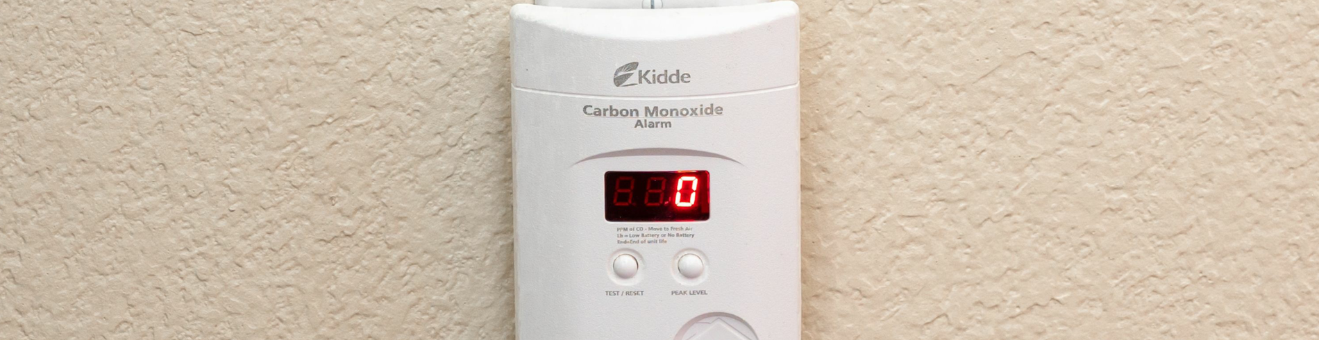 Photo of a CO alarm plugged into a wall