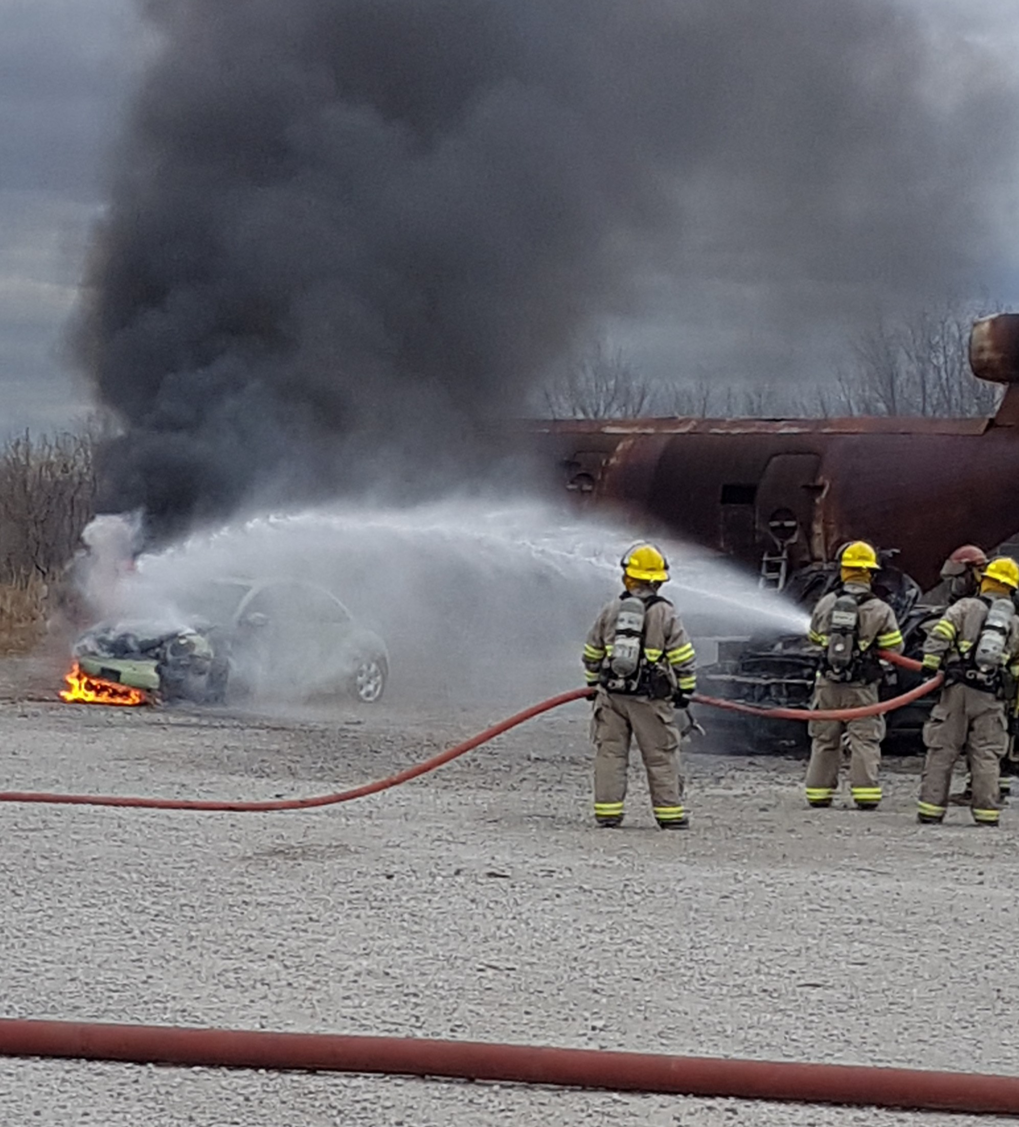 Firefighters putting out a car fire 