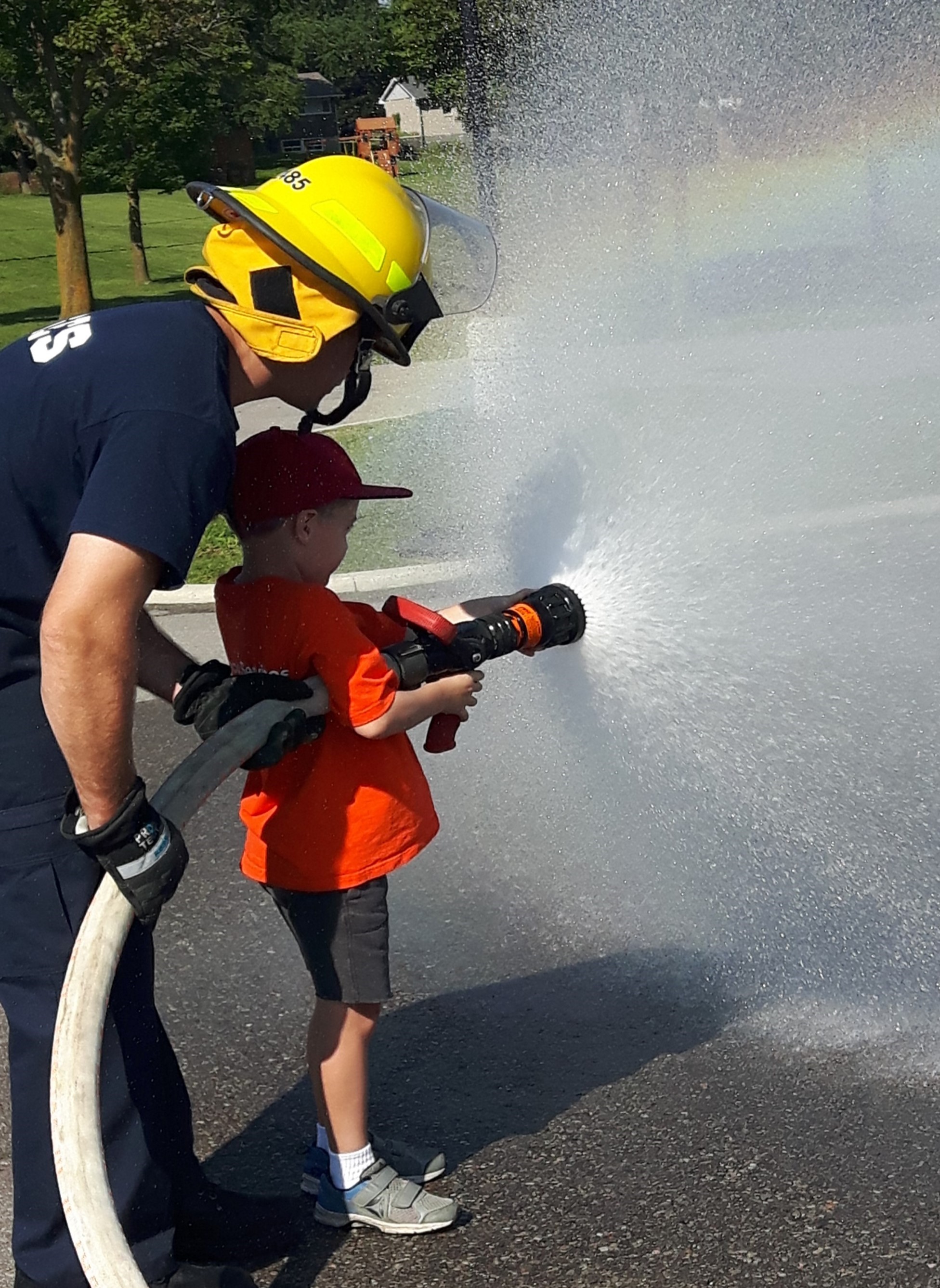 A firefighter demonstrates using a fire hose.