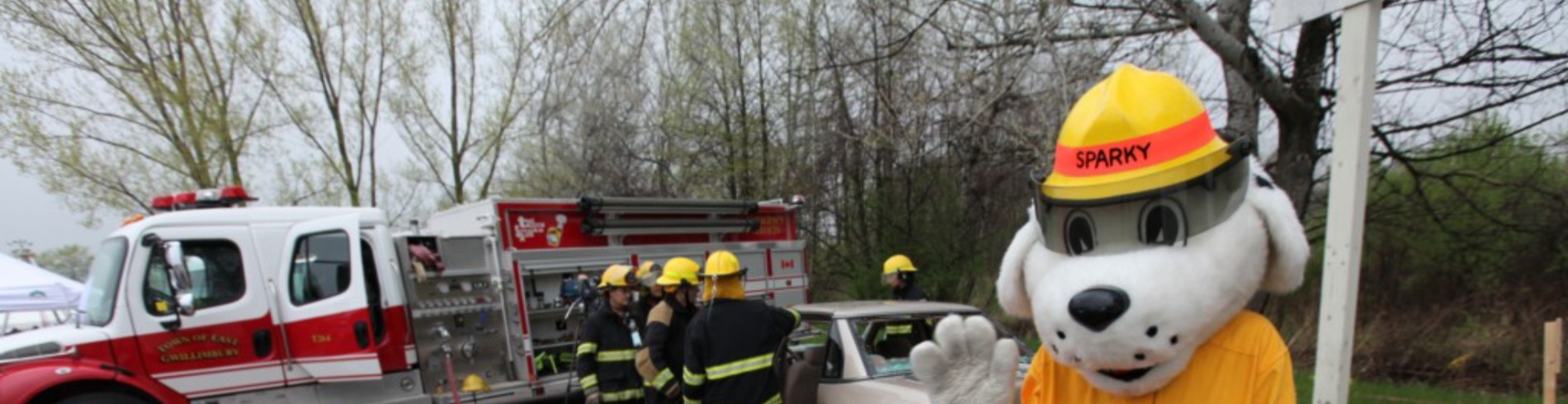 Sparky the fire dog waving during a firefighter demonstration. 