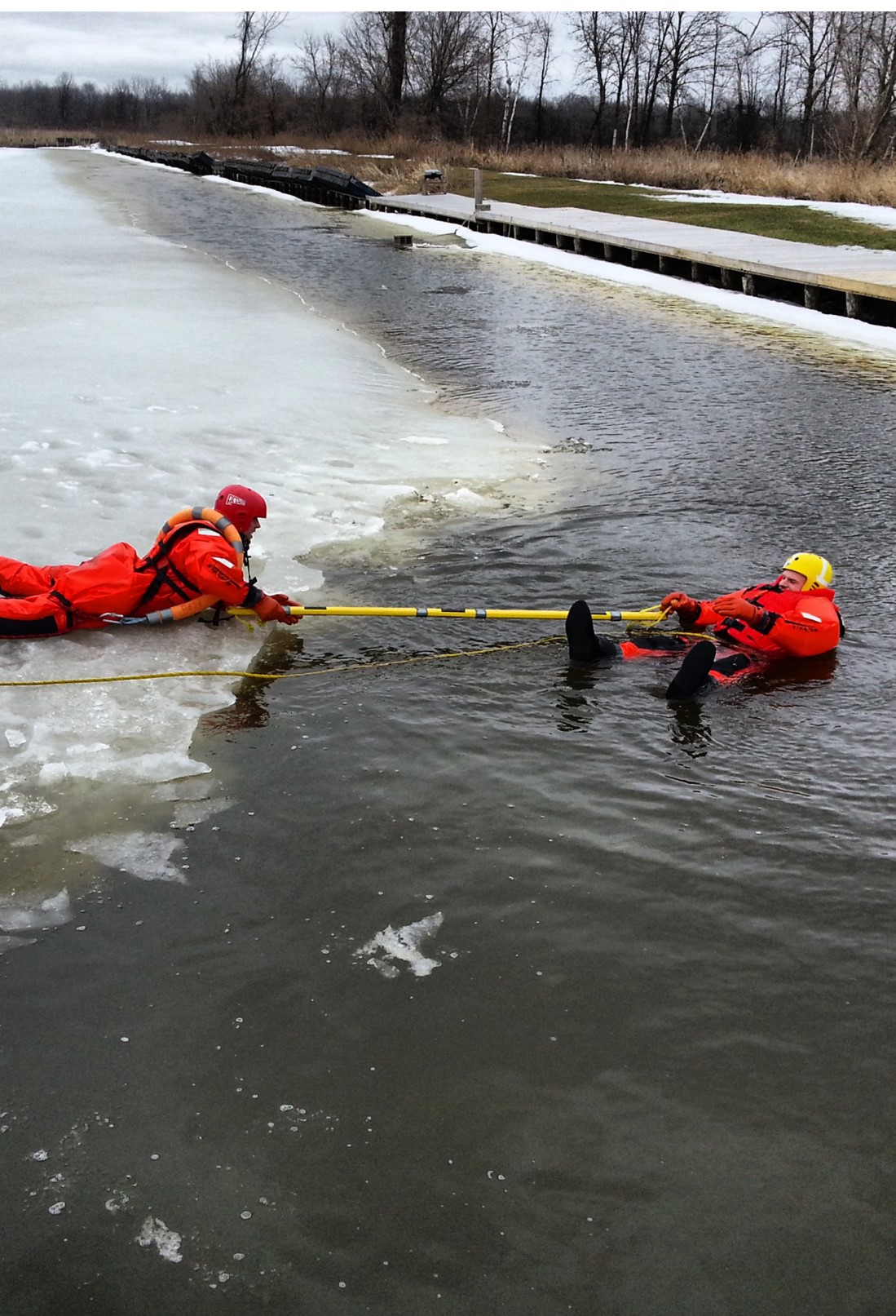 Firefighters practice ice water rescue skills.