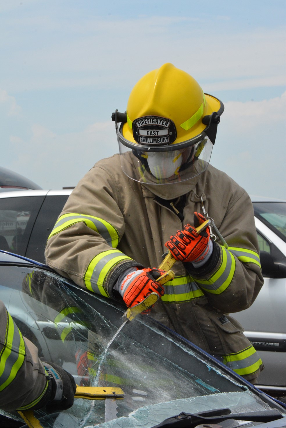 Firefighters breaking open a window