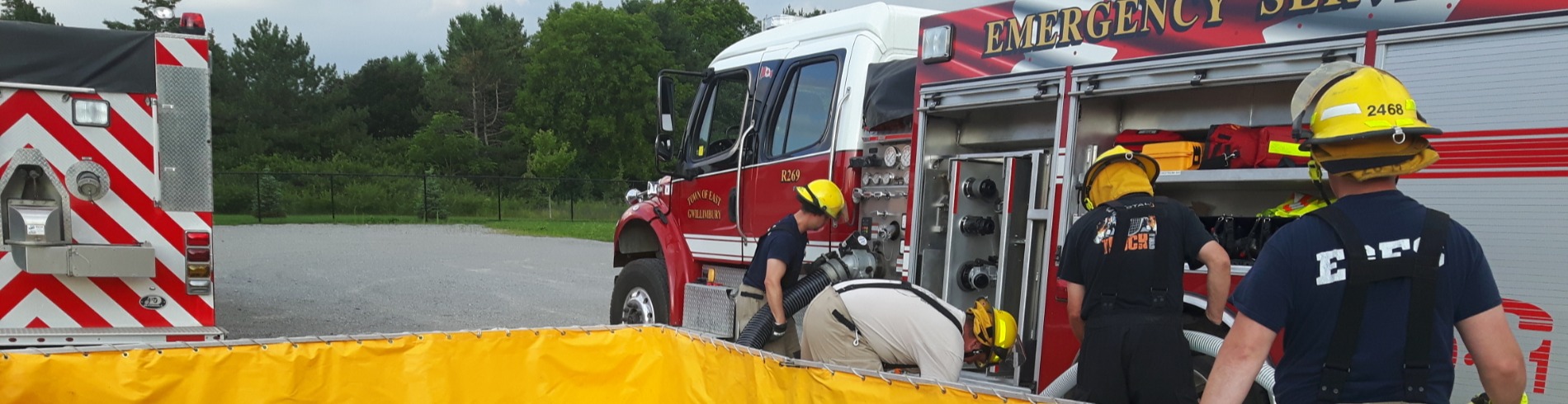 Firefighters preparing hose equipment