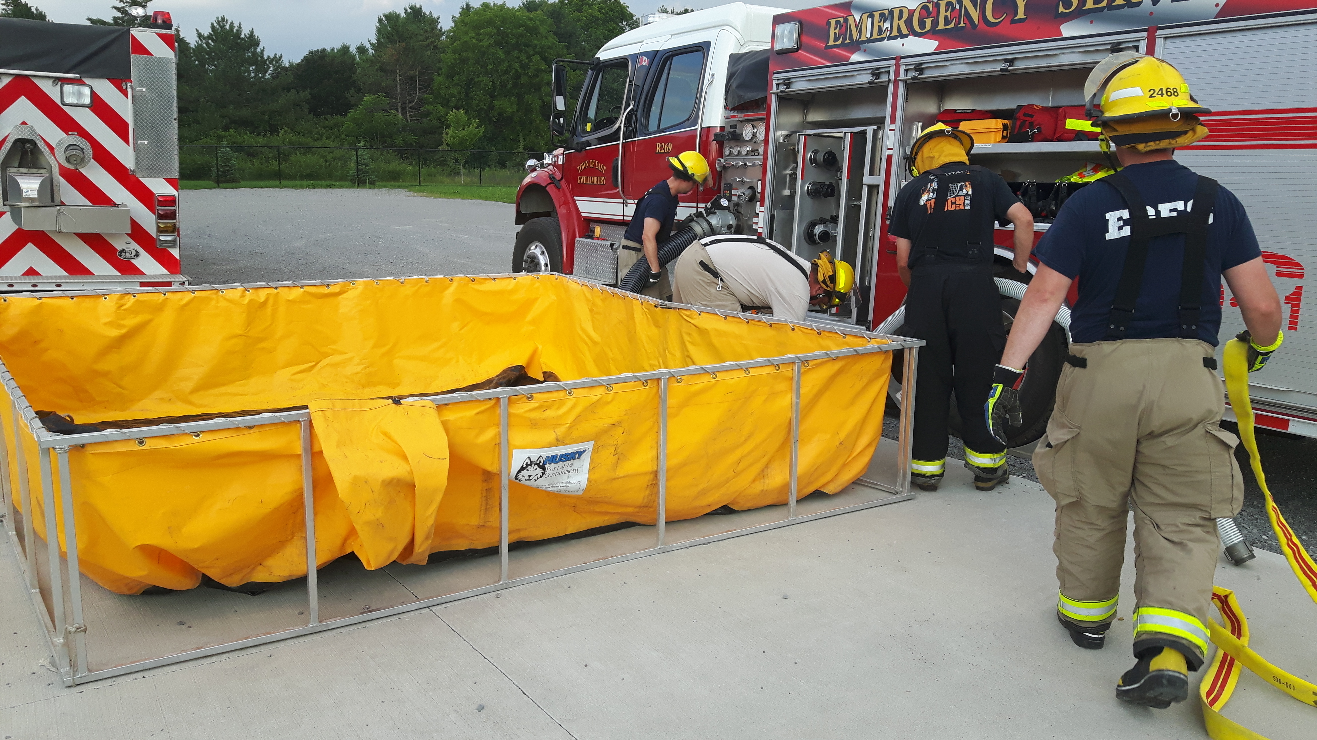 Firefighters practice water tanker shuttle operations.