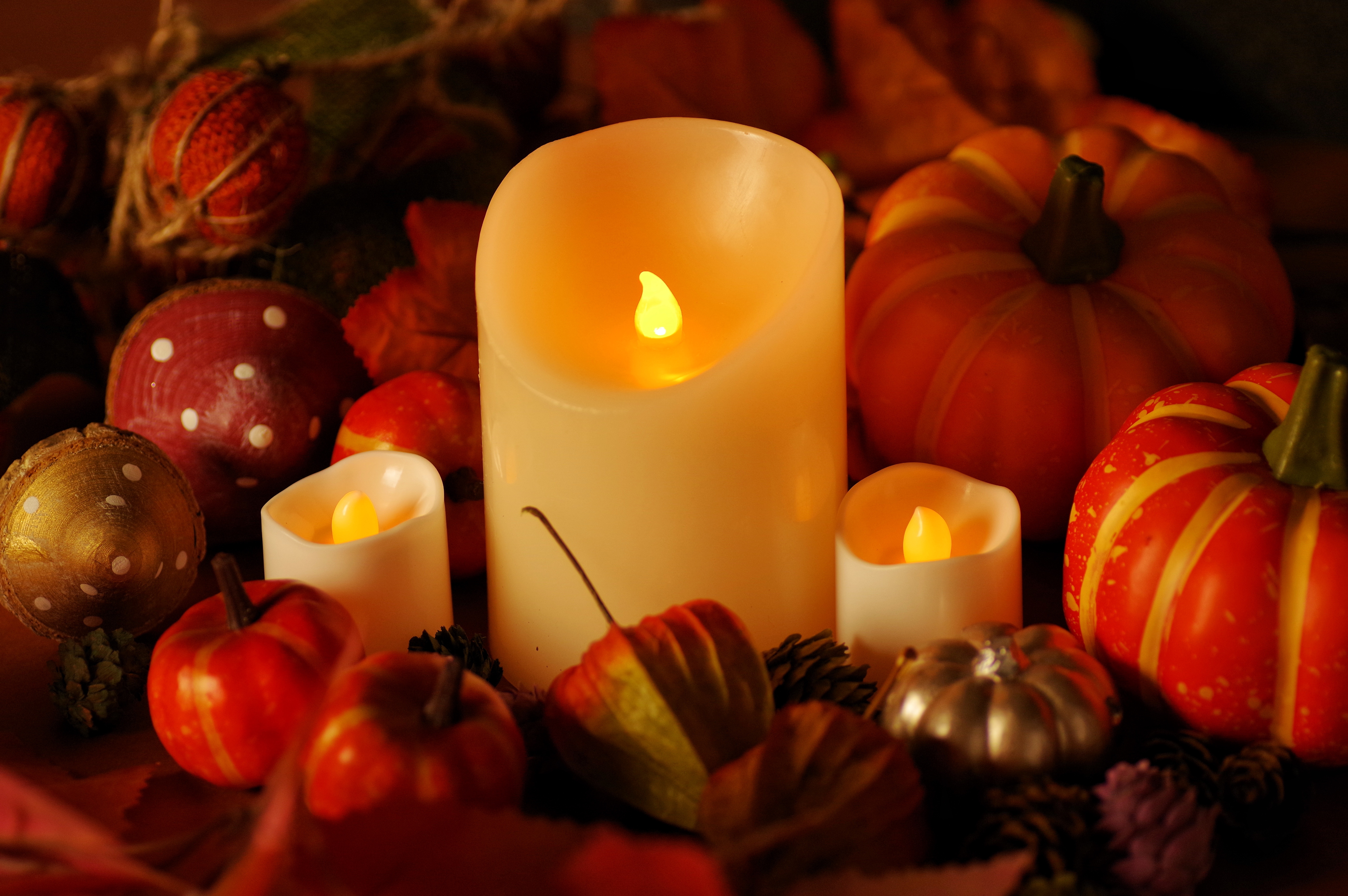 Image of fake candles beside pumpkins