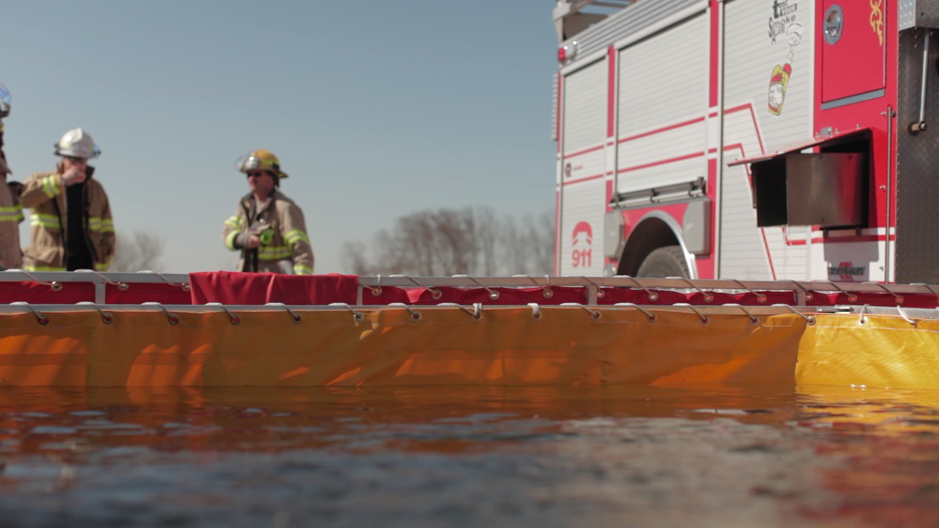 A portable tank is filled with water during a training exercise for tanker shuttle services.