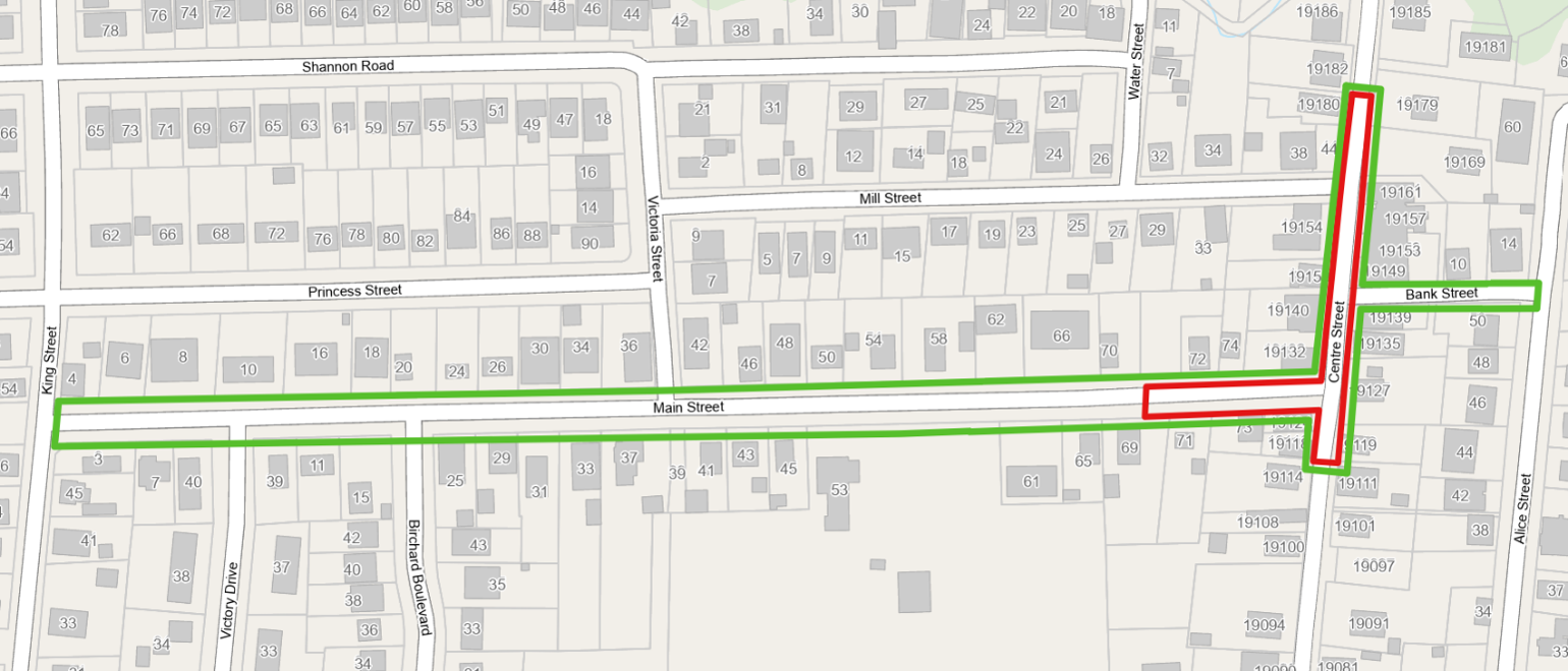 Map of the Mount Albert Downtown Revitalization paving area showing temporary road closures and traffic impacts. A red-highlighted section indicates a full closure on Centre Street, extending from approximately 40 metres north of Mill Street to 30 metres south of Main Street, and a short section of Main Street west of Centre Street. Green-highlighted sections show the remaining paving limits on Main Street and Bank Street, where rolling lane closures will be in effect and traffic will be directed by flaggers. Surrounding streets and properties are displayed for reference.  Provide your feedback on BizChat