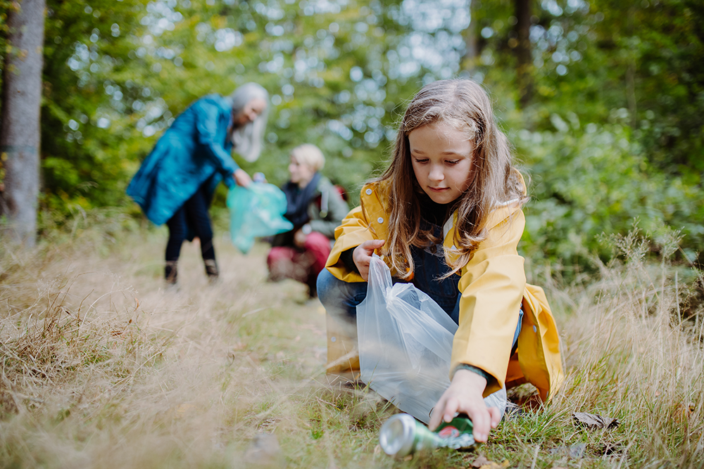 Little girl picking up garbage