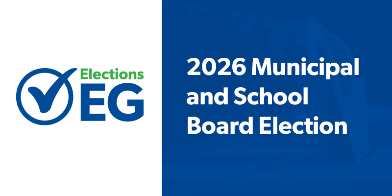 Graphic promoting the 2026 Municipal and School Board Election. The left side features the Elections EG logo with a blue checkmark inside a circle and the words “Elections EG” in blue and green. The right side has a blue background with white text reading “2026 Municipal and School Board Election,” overlaid on a faint image of a ballot being placed into a ballot box.