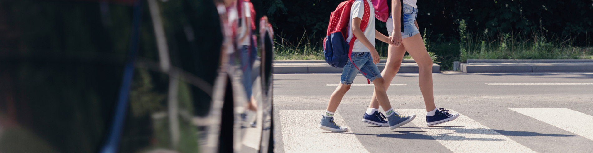 Young kids walking across a crosswalk