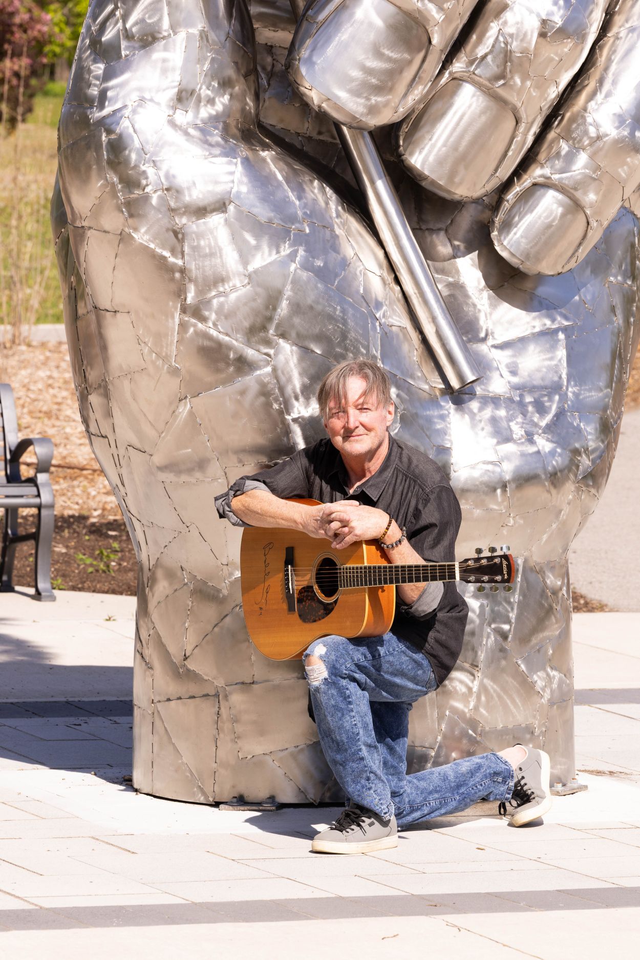 Michael Hanson in front of "Holding Hope" Sculpture